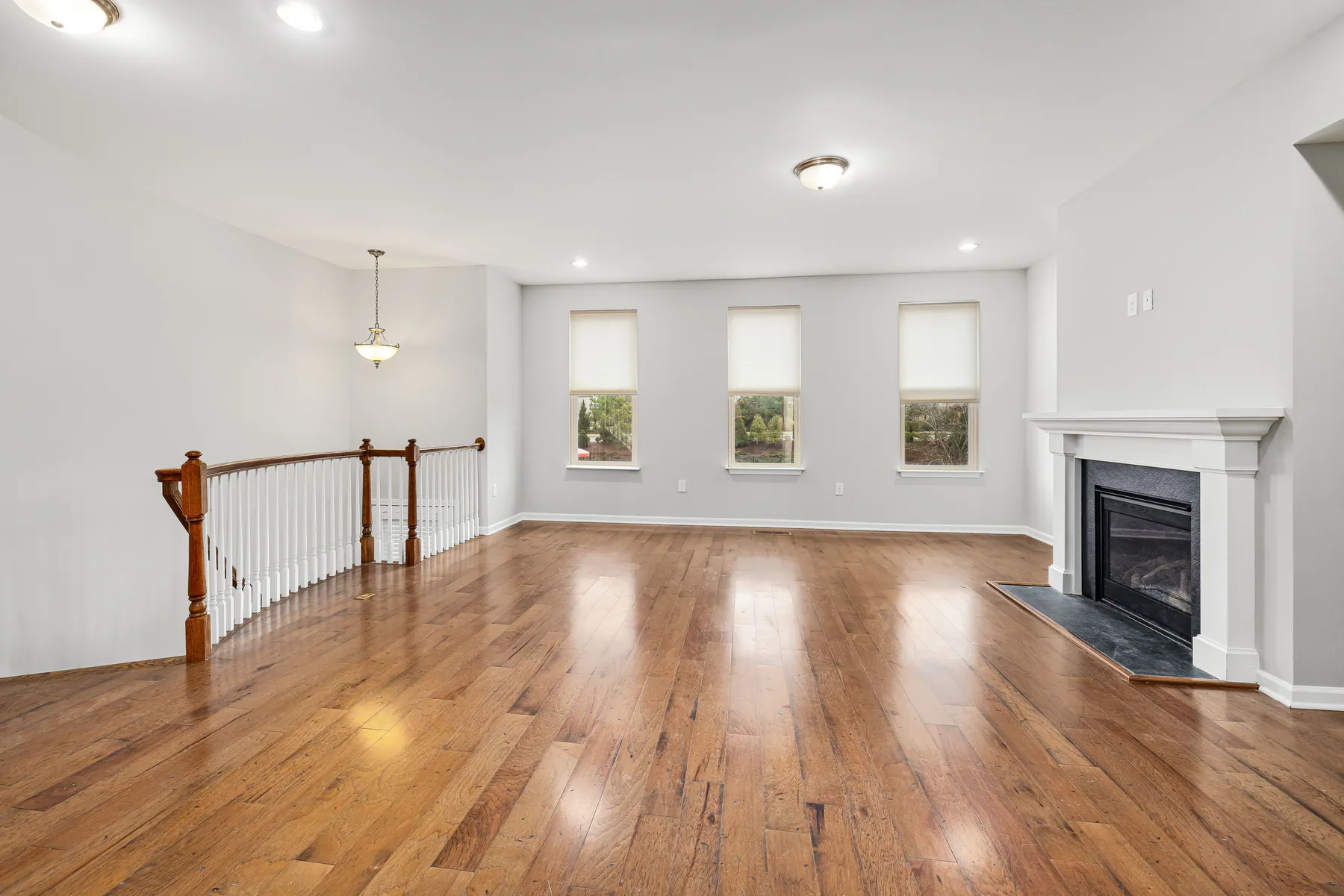 Empty move-in-ready room with clean hardwood floors