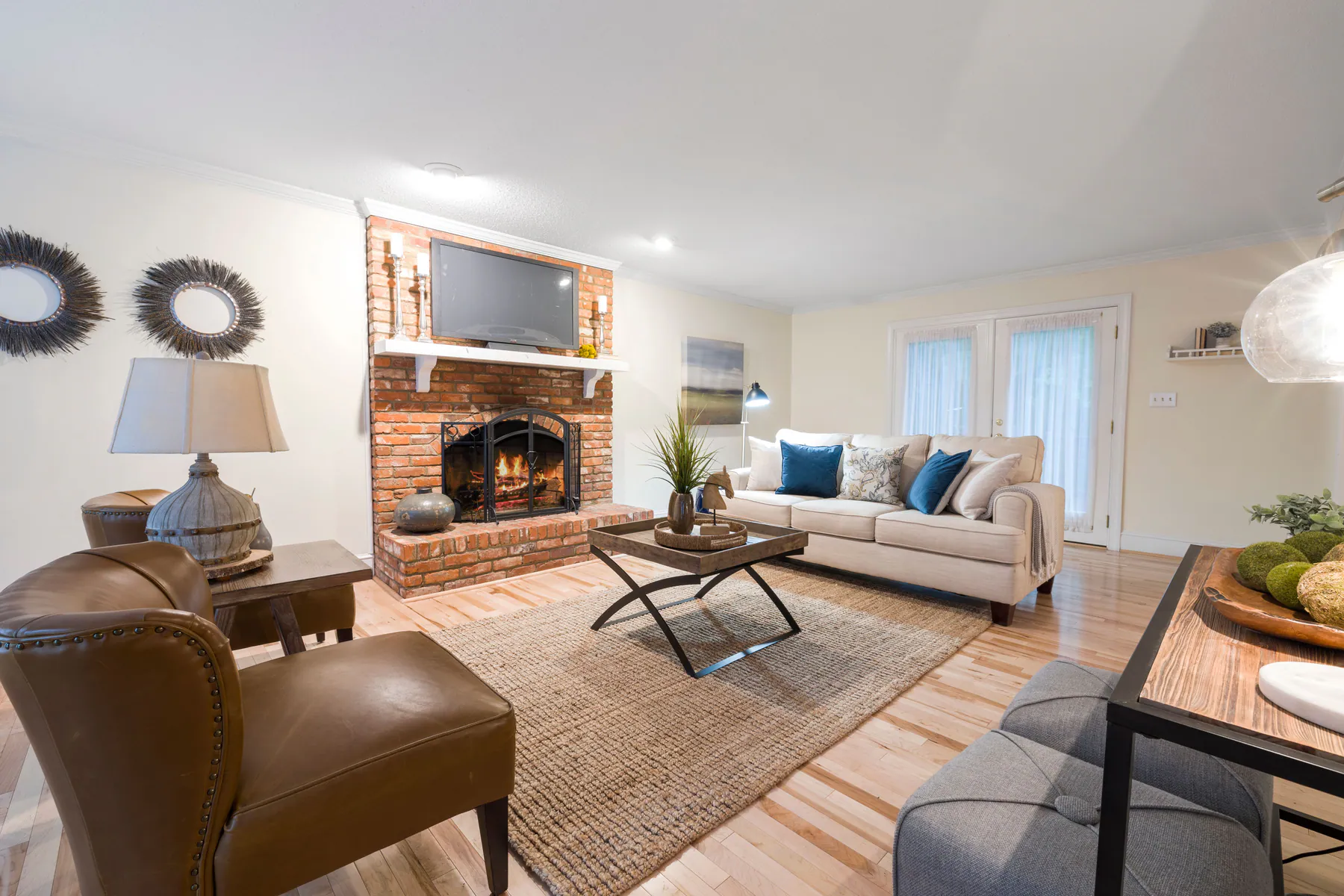 Bright residential living room with clean hardwood floors and arranged furnishings
